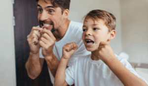 Family dentist in Edmonton at Petrolia Dental Edmonton demonstrating proper oral hygiene techniques for different age groups