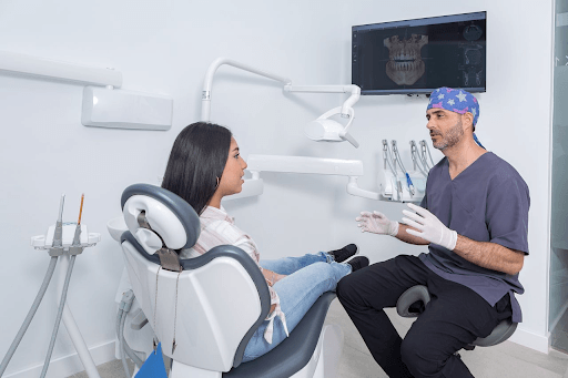 Dentist discussing the dental implant process with an adult patient at a dental consultation